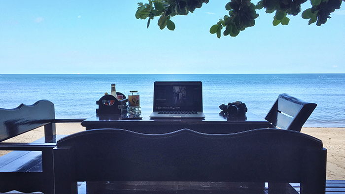 digital nomad working from the beach